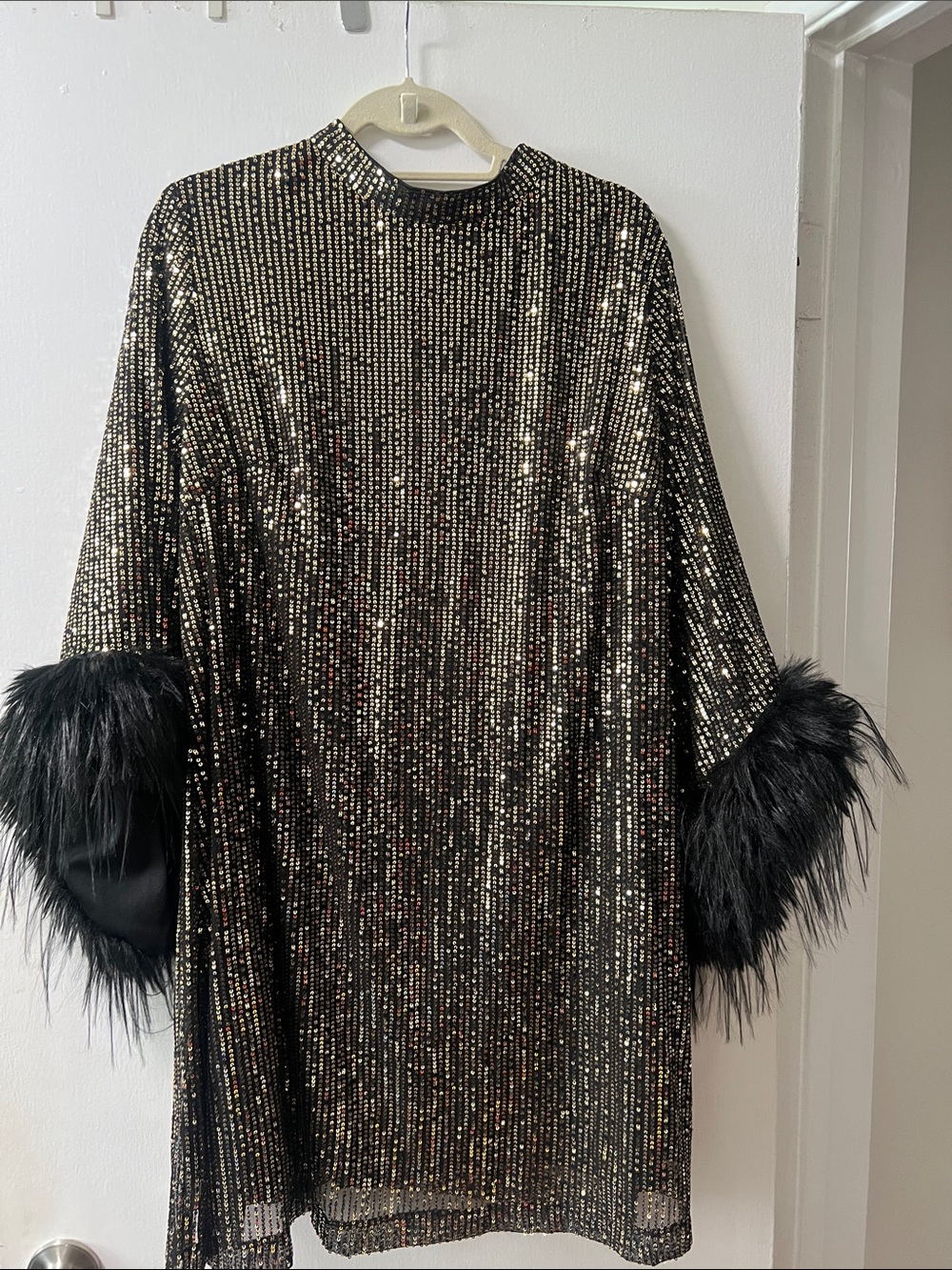 Sequin mini dress with fur trimmed sleeves